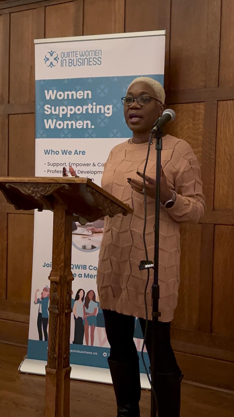 Aileen M. Edwards speaking at a podium
